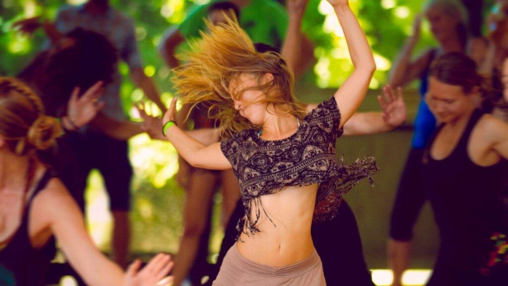 Woman releasing emotion and feeling joy with ecstatic dance